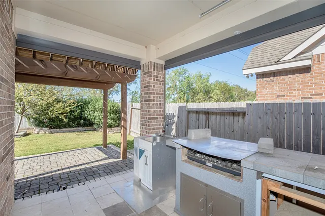 a view of a porch with furniture and a yard