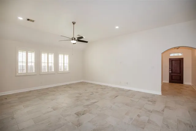 an empty room with windows and closet