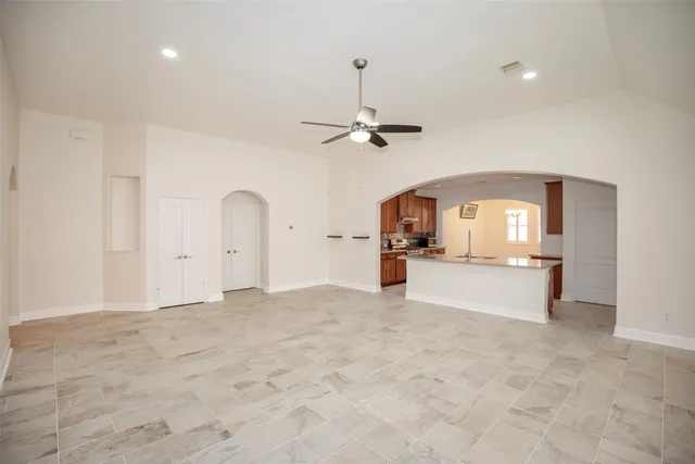 a view of a kitchen with a sink and a mirror