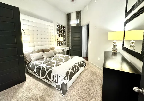 a bedroom with a bed and a night stand