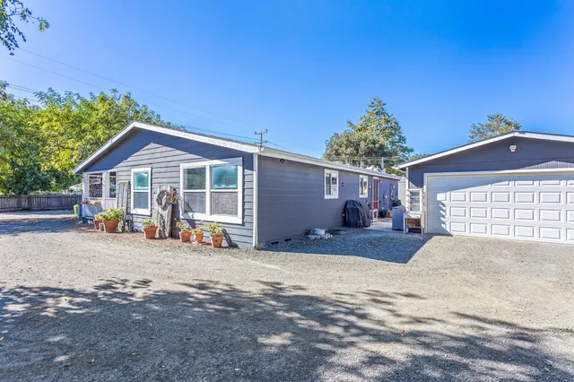 a view of a patio with table and chairs under an umbrella