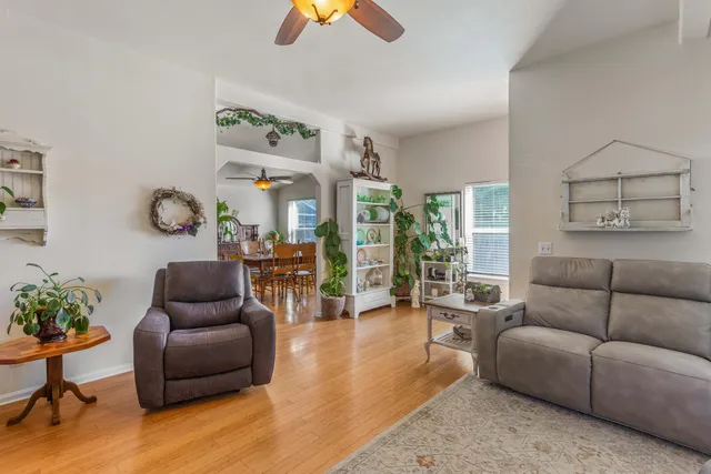 a living room with furniture and a painting on the wall