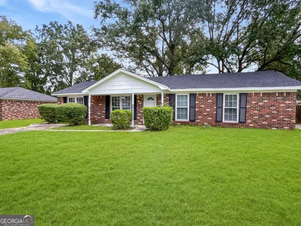 a front view of a house with a yard