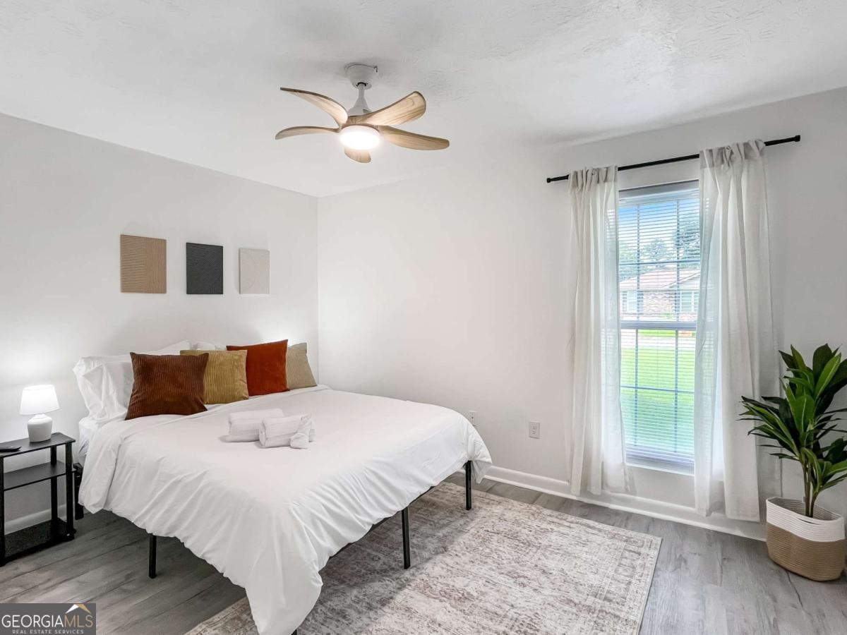 1224 Crawford Way Pooler, GA 31322 - Photo 7 of 12 a bedroom with a bed and a potted plant