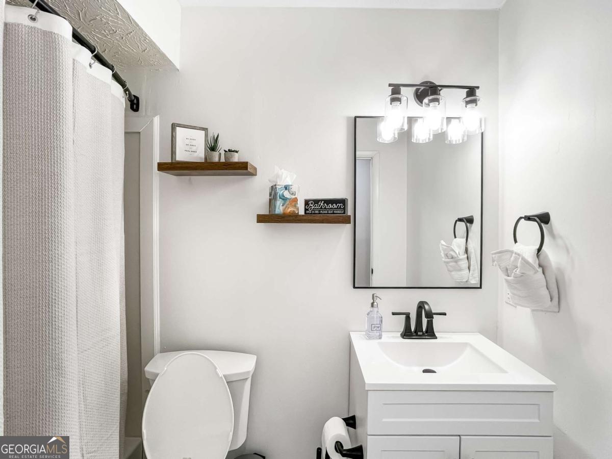 1224 Crawford Way Pooler, GA 31322 - Photo 8 of 12 a bathroom with a sink vanity mirror and toilet