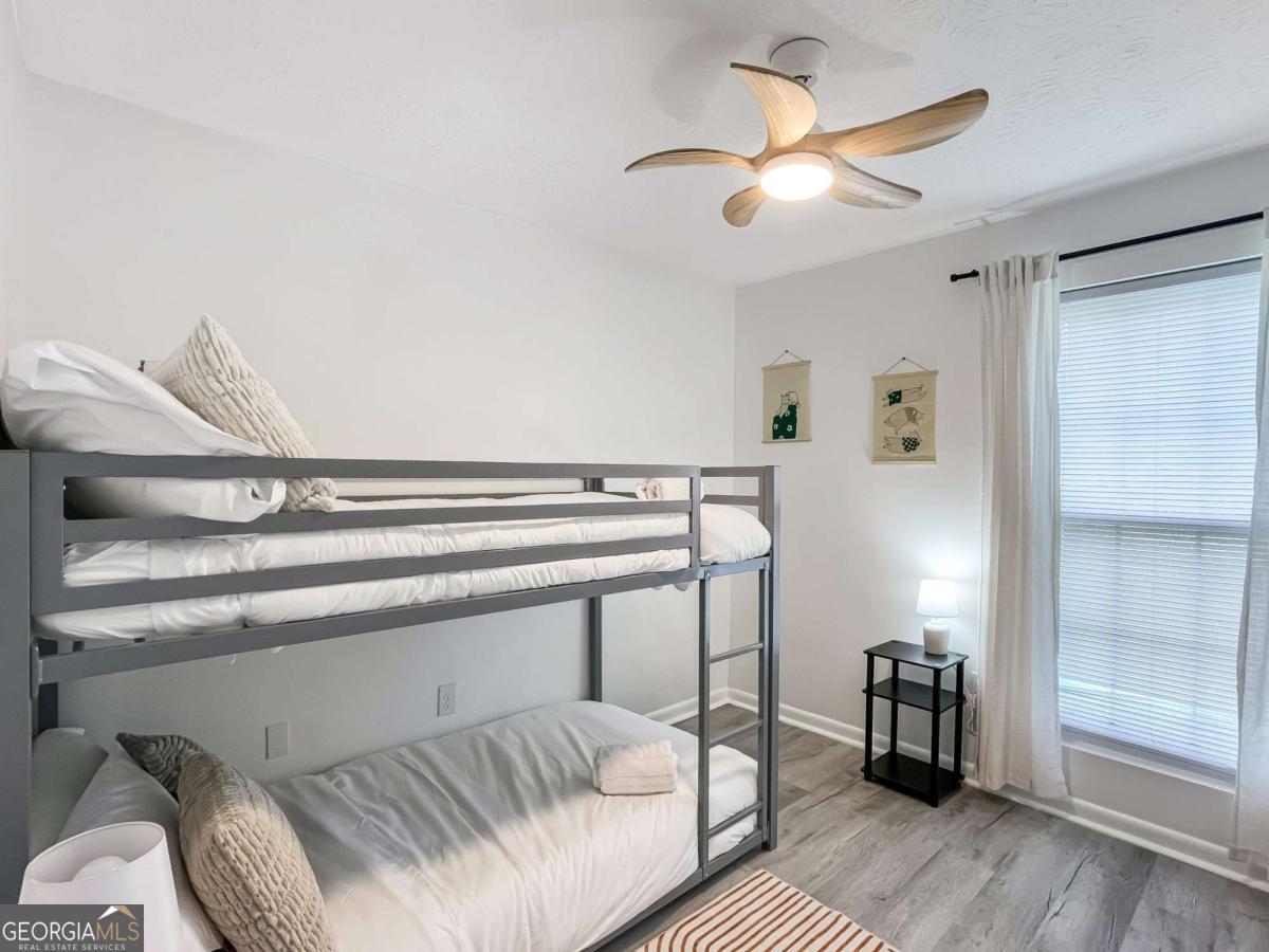 1224 Crawford Way Pooler, GA 31322 - Photo 10 of 12 a bedroom with a bed and a chandelier