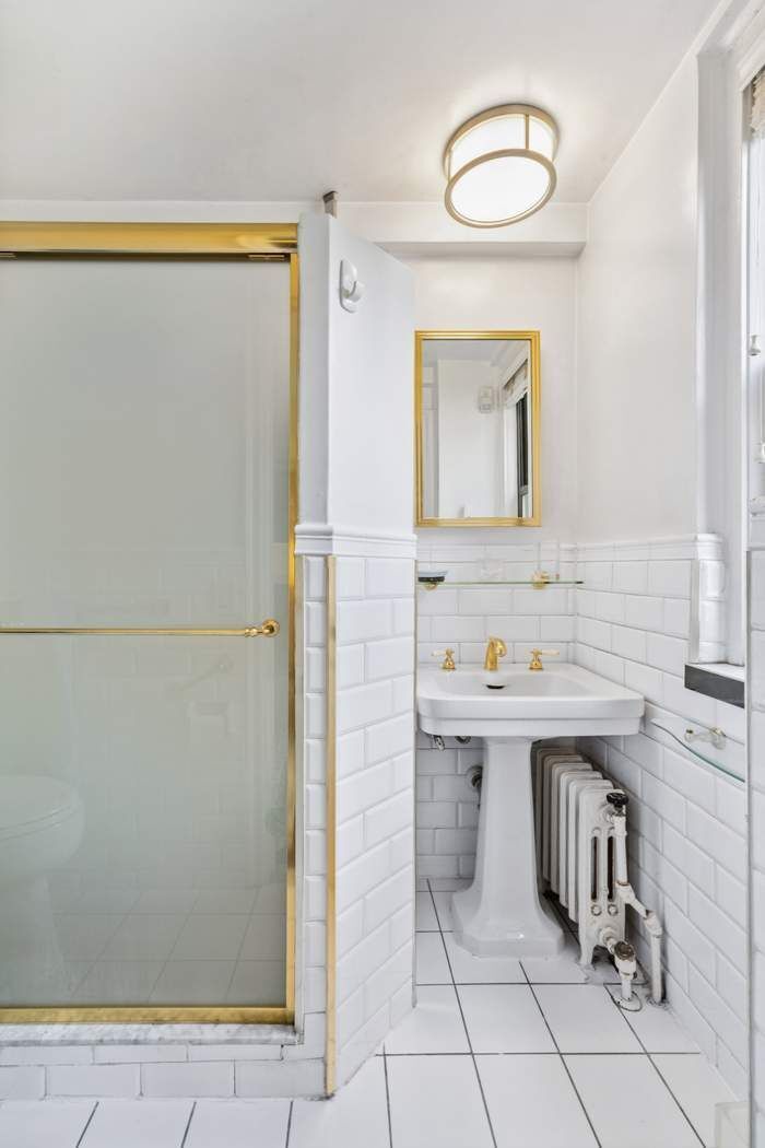 333 East 53rd Street, Unit 5B Manhattan, NY 10022 - Photo 6 of 12 a bathroom with a sink a mirror and a shower