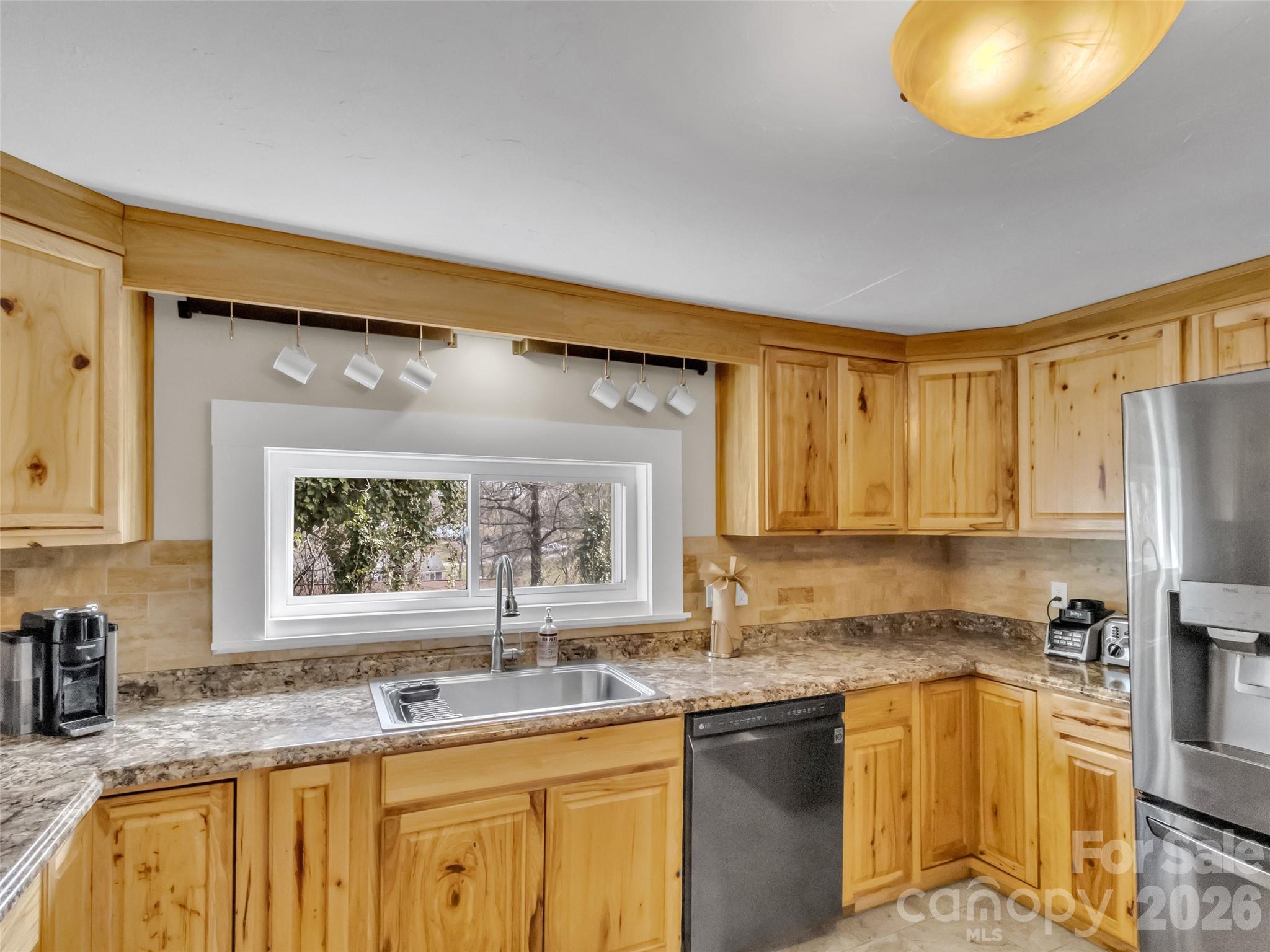 43 Melton Road Candler, NC 28715 - Photo 11 of 44 a kitchen with a sink stove and refrigerator
