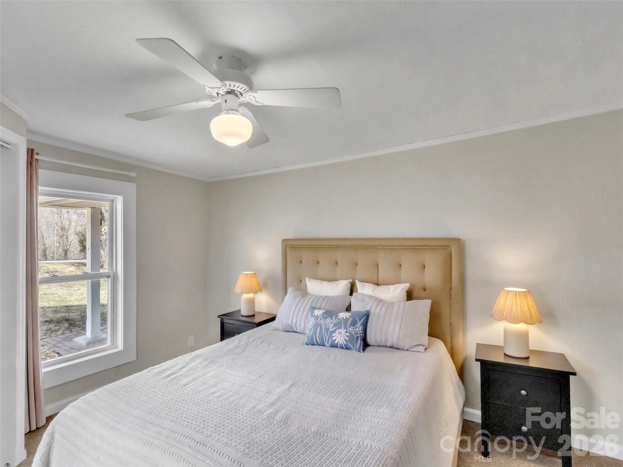 43 Melton Road Candler, NC 28715 - Photo 17 of 44 a bedroom with a bed and a window