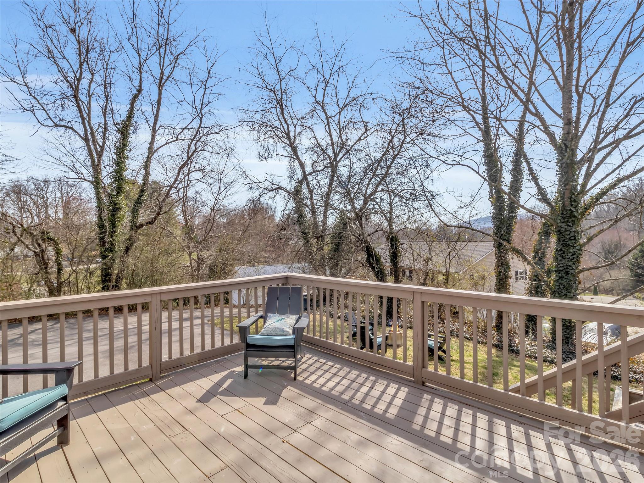 43 Melton Road Candler, NC 28715 - Photo 24 of 44 a view of a deck with two chairs and wooden fence