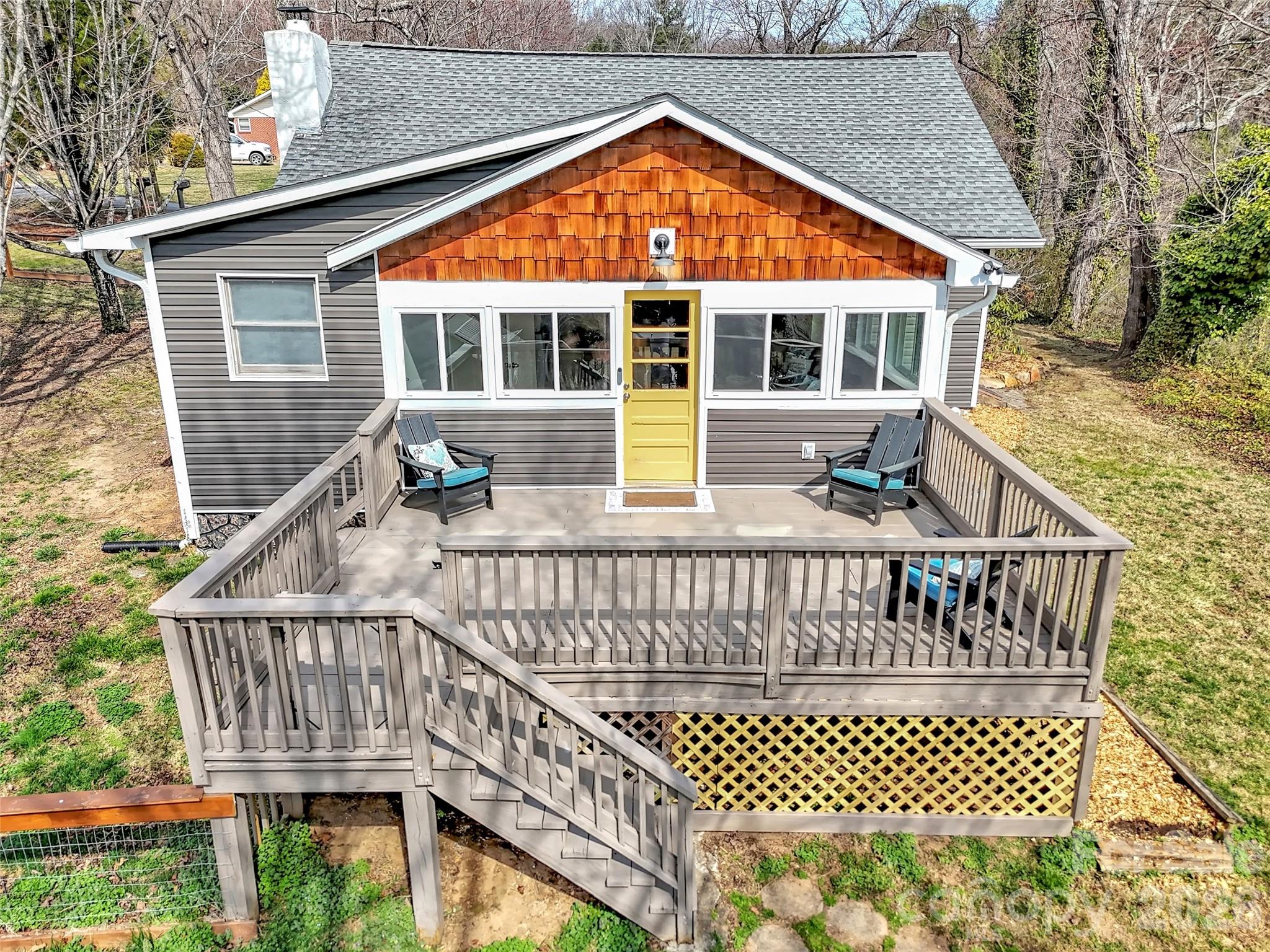 43 Melton Road Candler, NC 28715 - Photo 25 of 44 a view of a house with wooden deck and furniture