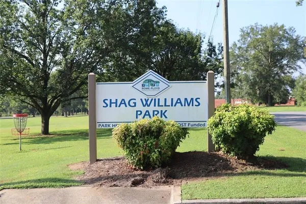 a sign board with a park bench