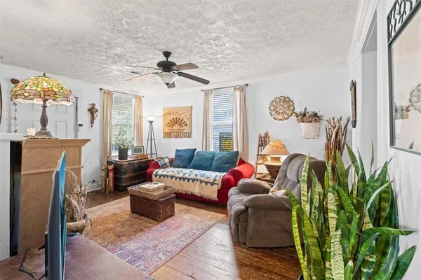 a living room with furniture a fireplace and a rug
