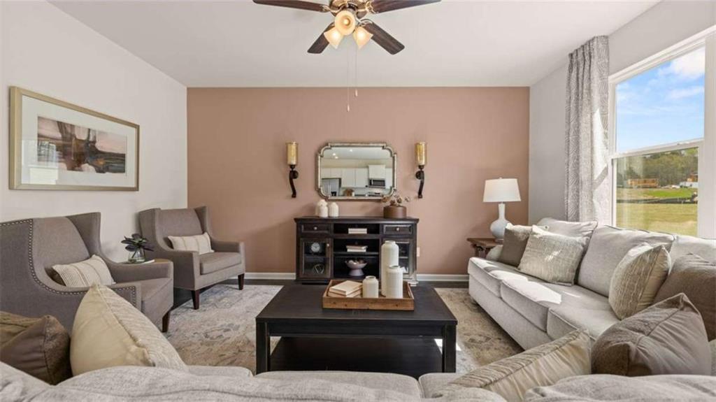 318 Friendship Oak Way Hampton, GA 30228 - Photo 16 of 41 a living room with furniture and wooden floor
