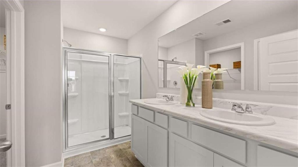 318 Friendship Oak Way Hampton, GA 30228 - Photo 21 of 41 a bathroom with a double vanity sink and a mirror