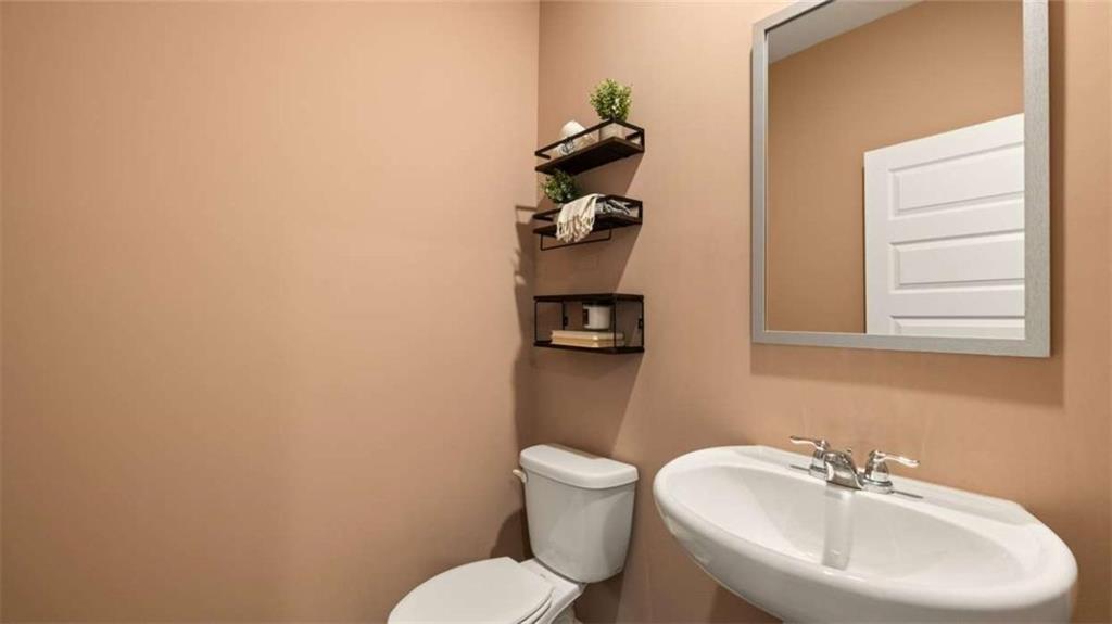 318 Friendship Oak Way Hampton, GA 30228 - Photo 6 of 41 a bathroom with a toilet sink and mirror