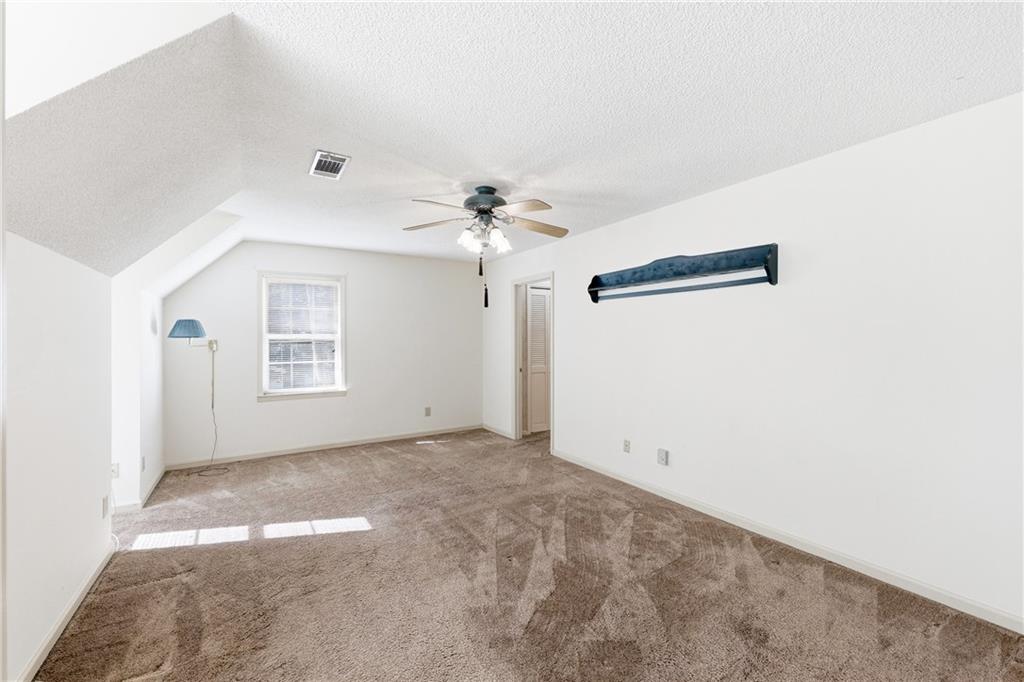 3608 Maple Forge Lane Gainesville, GA 30504 - Photo 23 of 45 an empty room with windows and chandelier fan