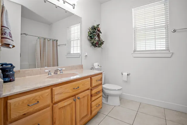 a bathroom with a double vanity sink and a toilet