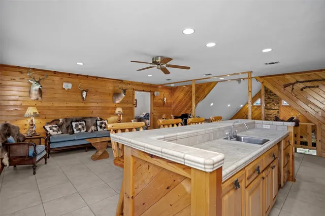 a kitchen with stainless steel appliances granite countertop a sink and a refrigerator