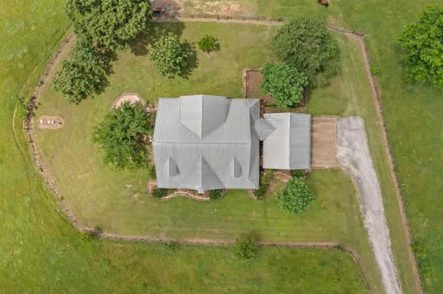 an aerial view of a house with a yard
