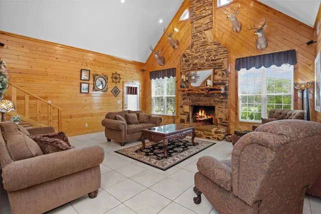 a living room with furniture a fireplace and a flat screen tv