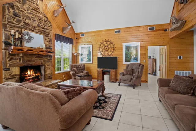 a living room with furniture a fireplace and a flat screen tv