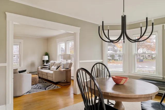 a living room with furniture a window and a chandelier
