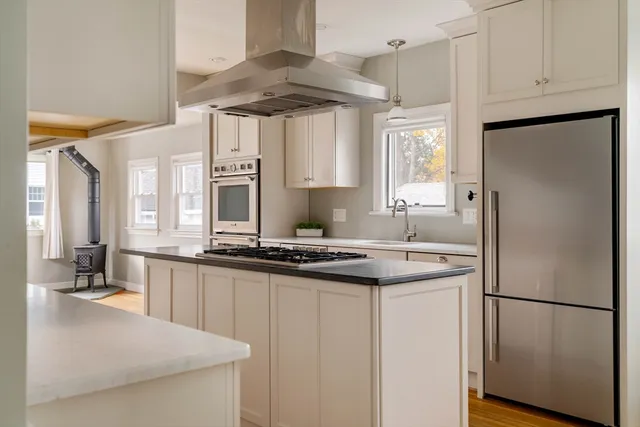 a kitchen with stainless steel appliances a sink stove and refrigerator