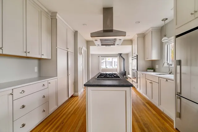 a kitchen with stainless steel appliances granite countertop a stove a sink and a refrigerator