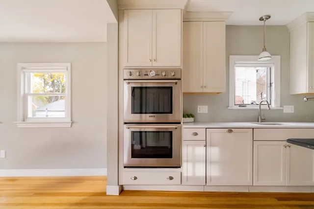 a kitchen with stainless steel appliances granite countertop a stove and a microwave