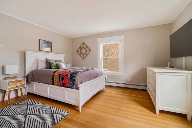 a bedroom with a bed and a window