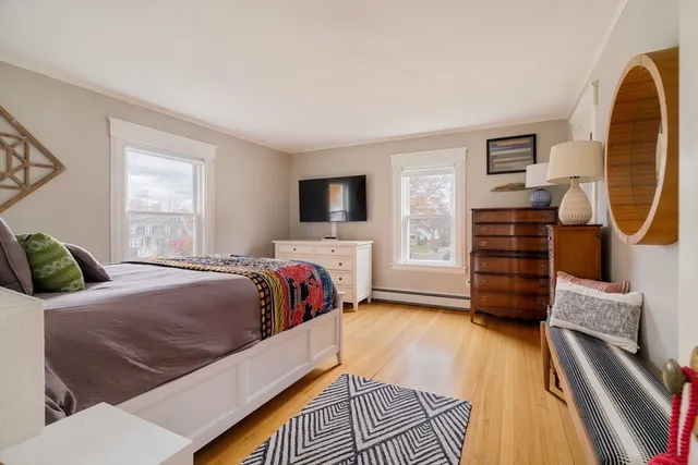 a bedroom with a bed and a flat tv screen