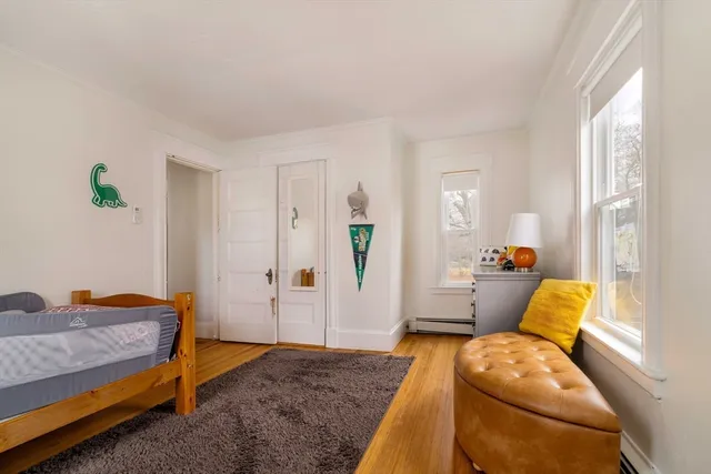a bedroom with furniture and a wooden floor