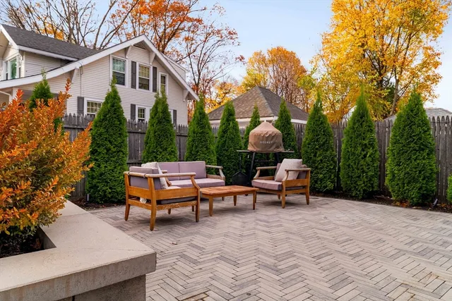 a backyard of a house with table and chairs