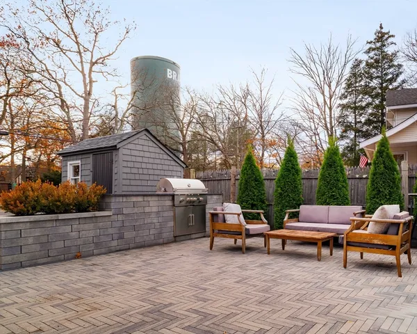 a view of backyard of house with outdoor seating