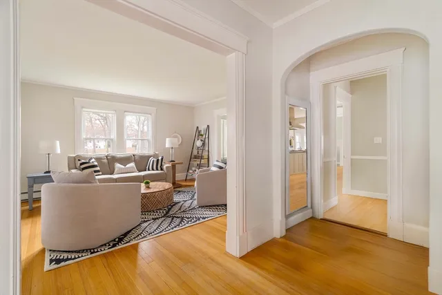 a living room with furniture a wooden floor and a window
