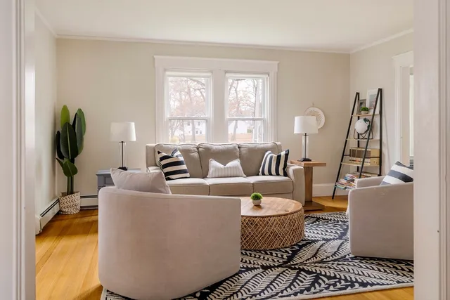 a living room with furniture floor to ceiling window and a flat screen tv
