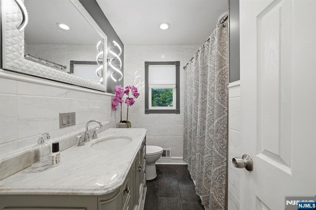 52 Barbara Drive Pompton Lakes, NJ 07442 - Photo 14 of 30 a bathroom with a sink toilet and shower
