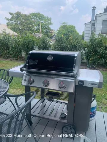 an outdoor sitting area with furniture and a fireplace