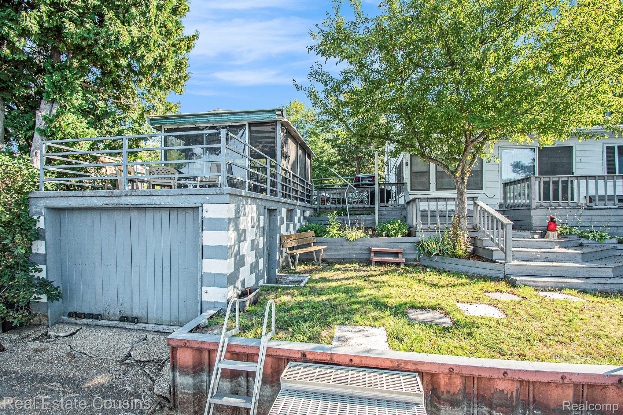 1734 Forest Road Harrison, MI 48625 - Photo 24 of 31 View of green lawn featuring a wooden deck