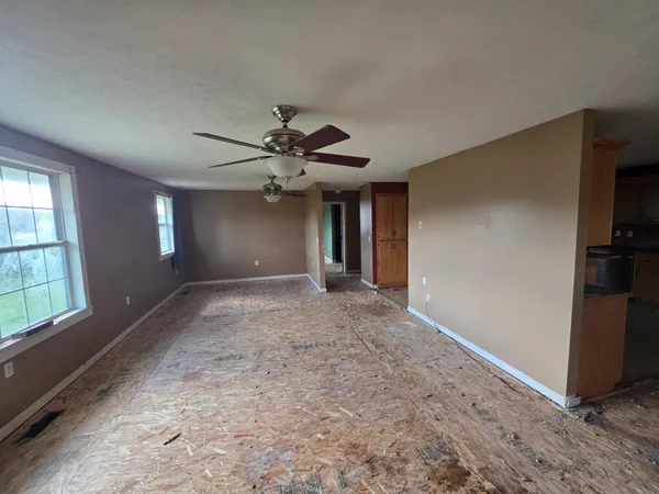a view of a livingroom with a ceiling fan and window