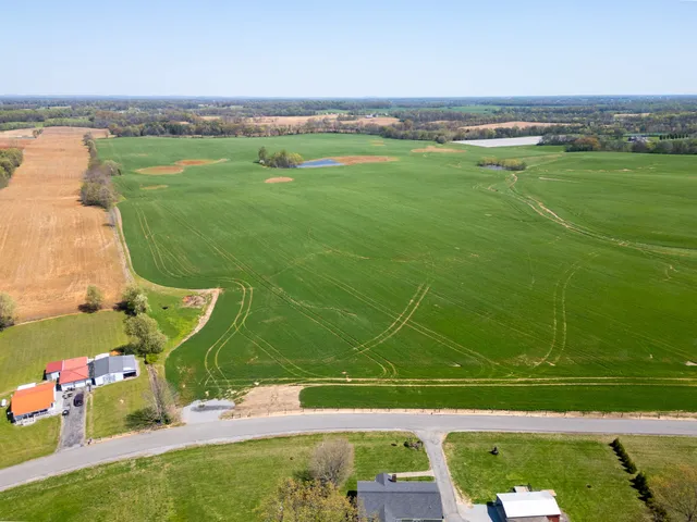 an aerial view of a golf course with chairs