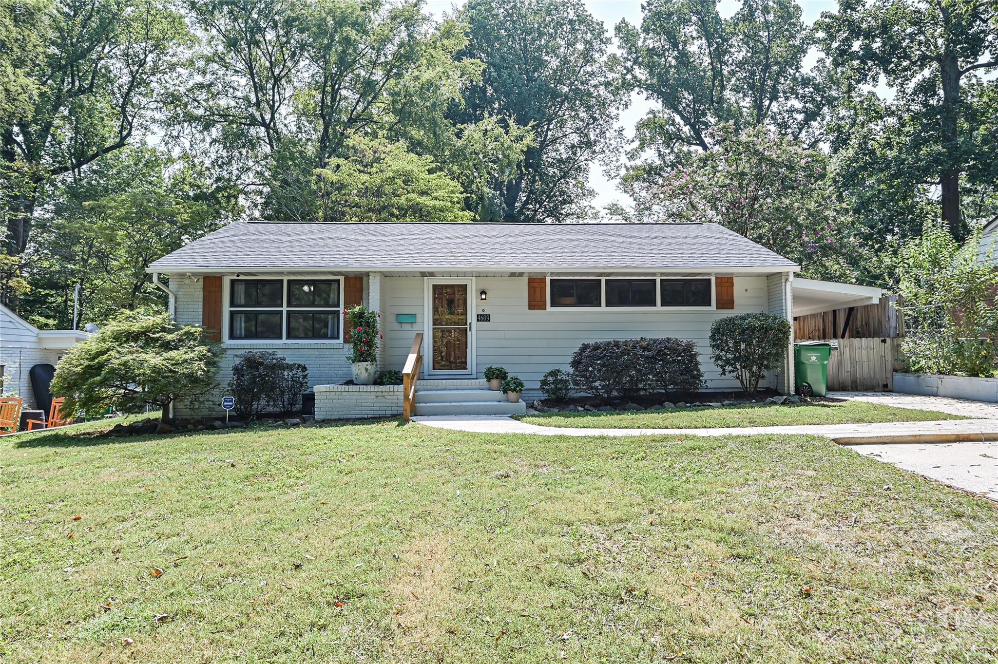 4609 Murrayhill Road Charlotte, NC 28209 - Photo 1 of 38 a front view of a house with a garden