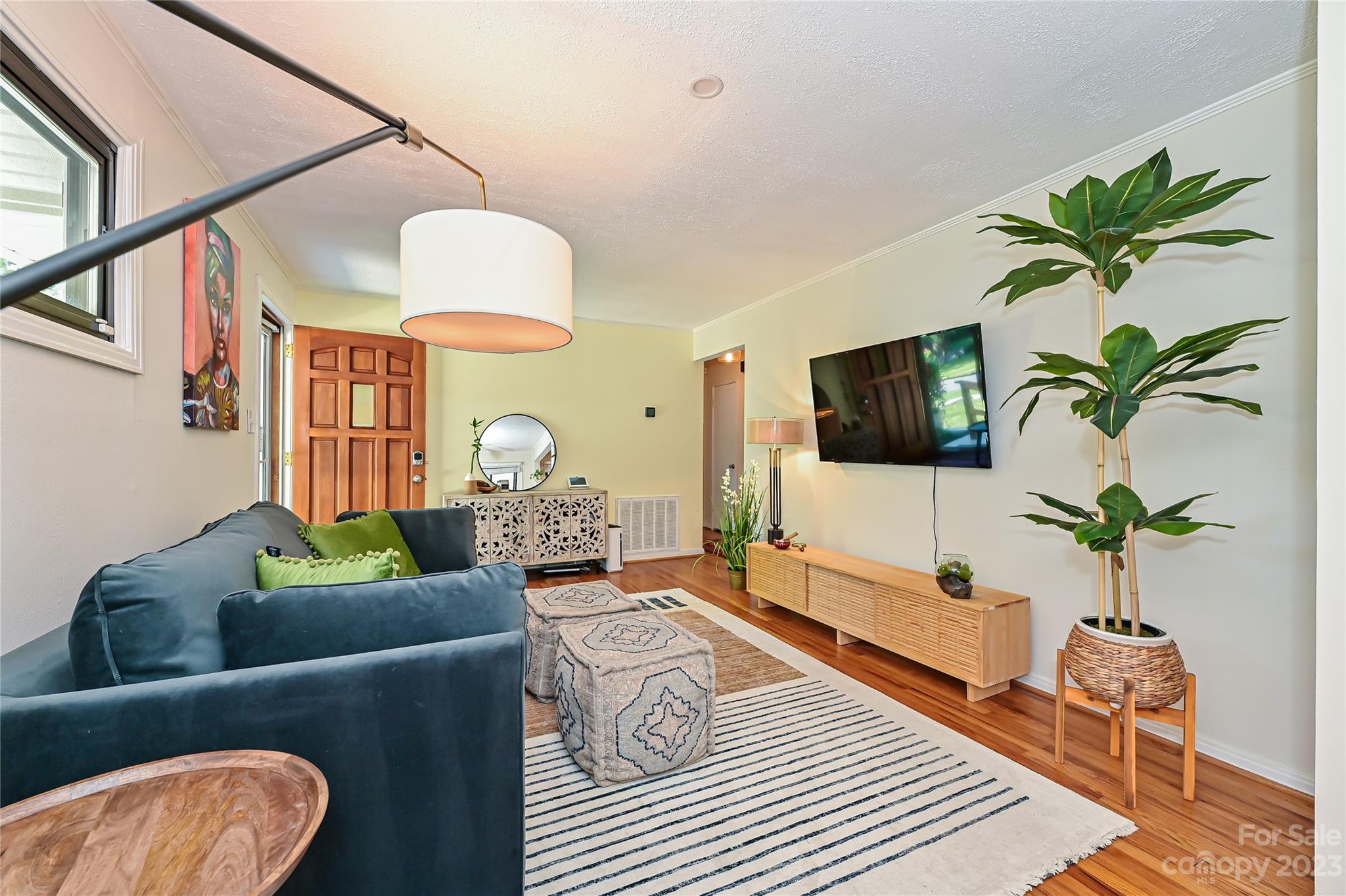 4609 Murrayhill Road Charlotte, NC 28209 - Photo 16 of 38 a living room with furniture and a flat screen tv