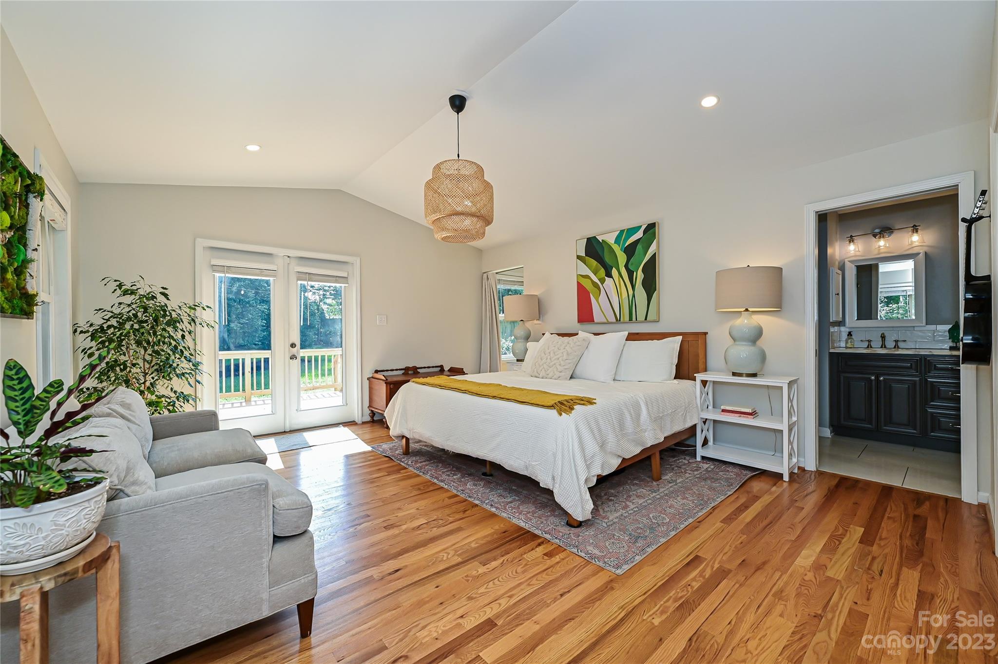 4609 Murrayhill Road Charlotte, NC 28209 - Photo 18 of 38 a spacious bedroom with a large bed and a wooden floor