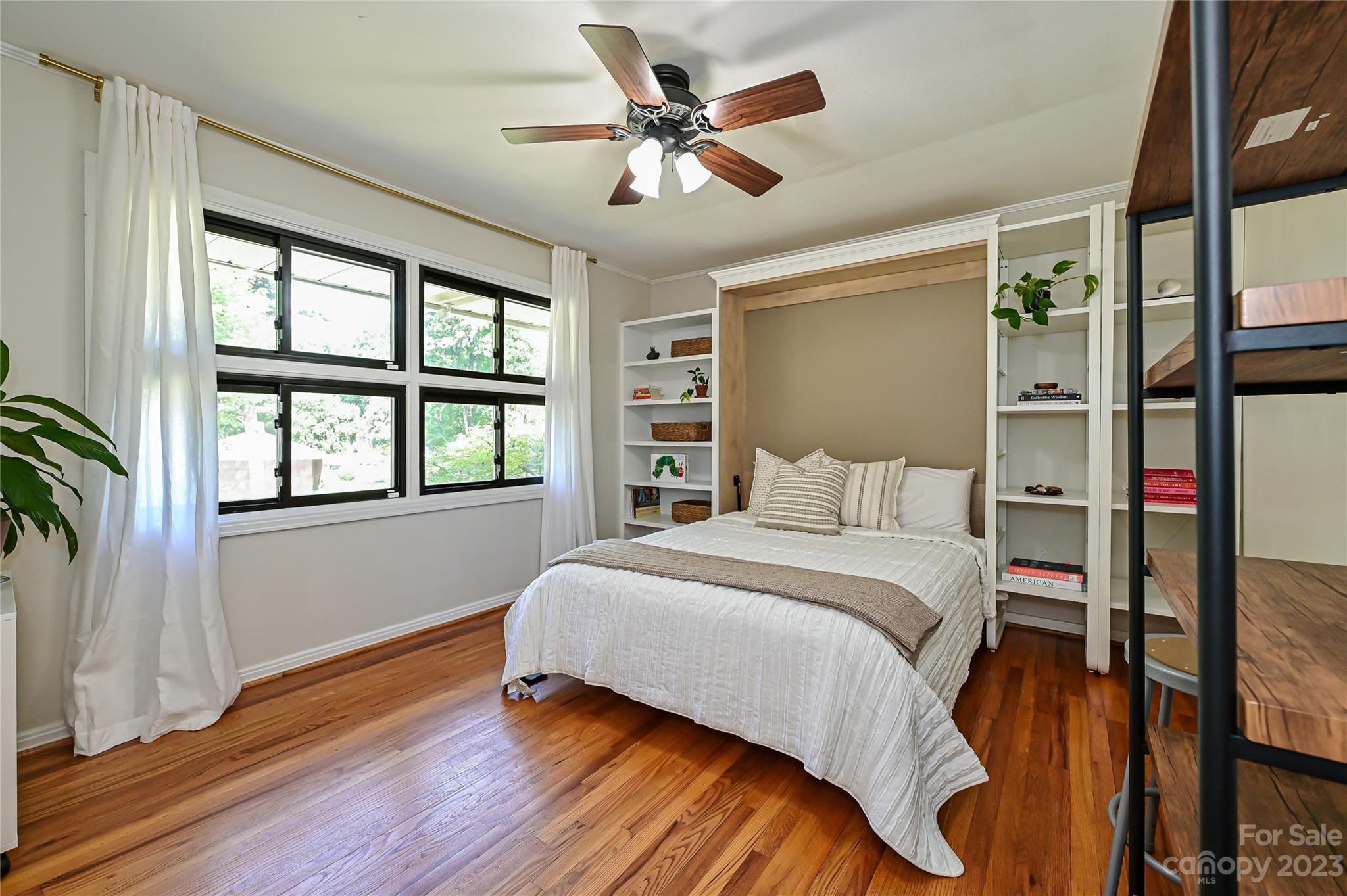 4609 Murrayhill Road Charlotte, NC 28209 - Photo 26 of 38 a bedroom with a bed and a large window with wooden floor