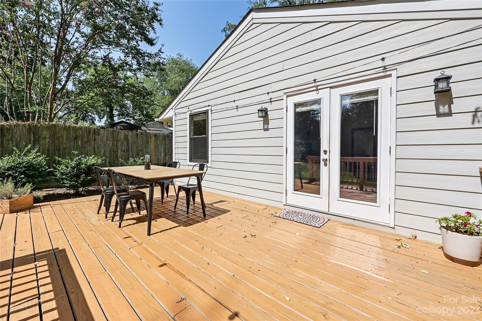 4609 Murrayhill Road Charlotte, NC 28209 - Photo 30 of 38 a patio with table and chairs and potted plants