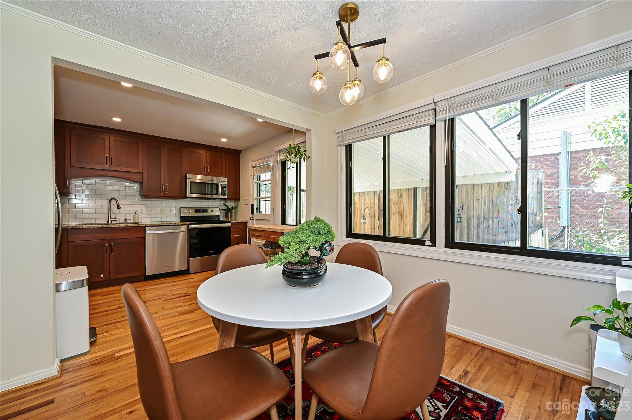 4609 Murrayhill Road Charlotte, NC 28209 - Photo 9 of 38 a view of a dining room with furniture window and wooden floor
