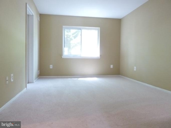 1782 Ivy Oak Square, Unit 79 Reston, VA 20190 - Photo 2 of 23 an empty room with a window