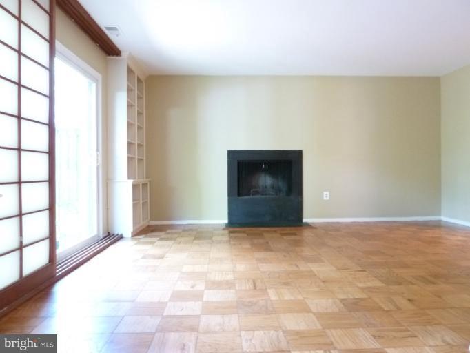1782 Ivy Oak Square, Unit 79 Reston, VA 20190 - Photo 17 of 23 a view of an empty room with a fireplace and a window